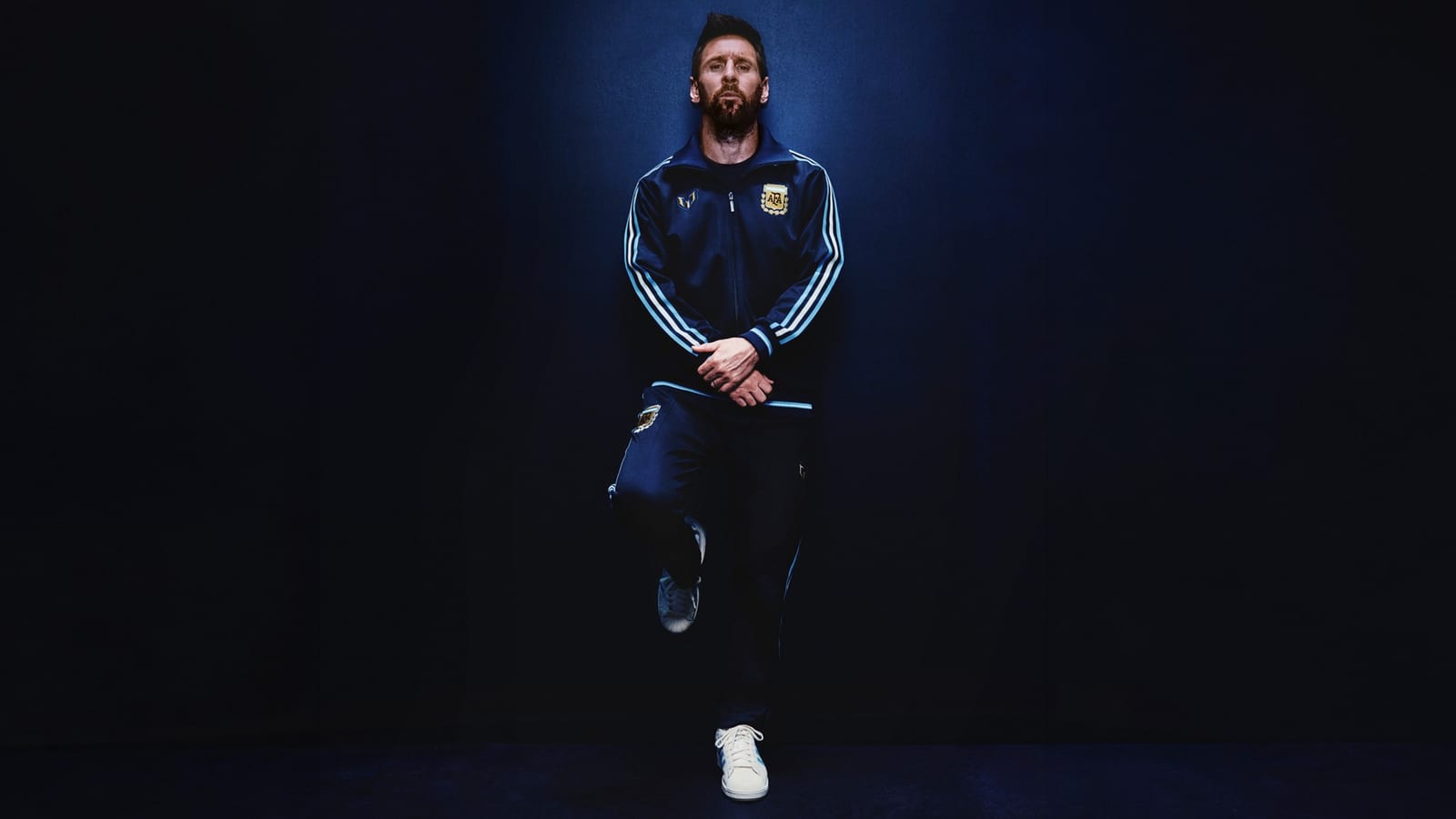 Lionel Messi in the navy adidas Argentina Messi 26 track top and track pants, with white stripes down the sleeves