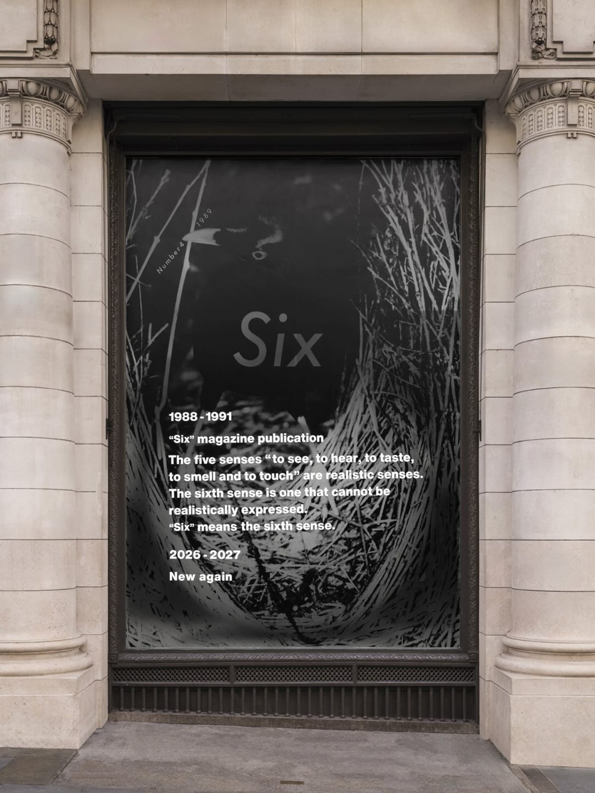 A Dover Street Market London window filled with a black-and-white photograph of a nest of twigs, Six in large grey letters, and white text reading 1988-1991, Six magazine publication, the five senses and the sixth, 2026-2027, New again