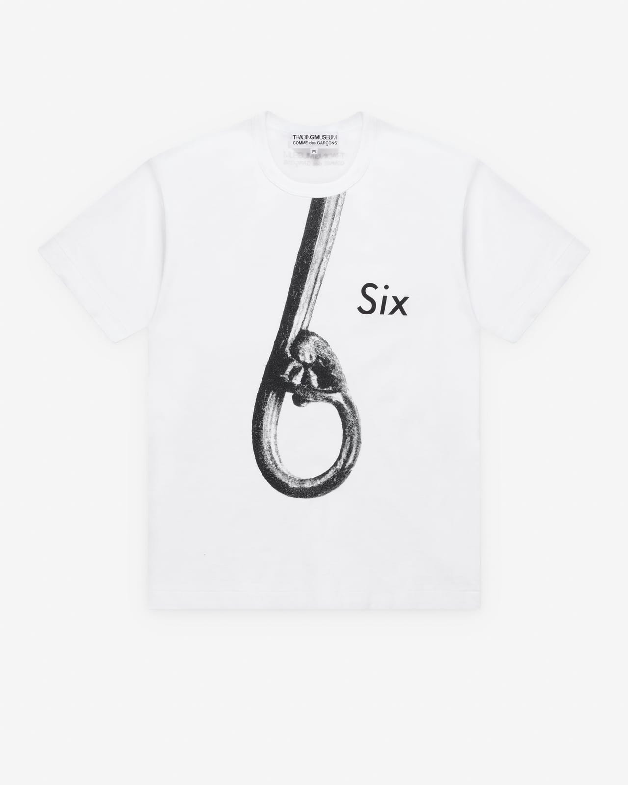 A white T-shirt printed with a large black looped figure 6 and the word Six in italic beside it
