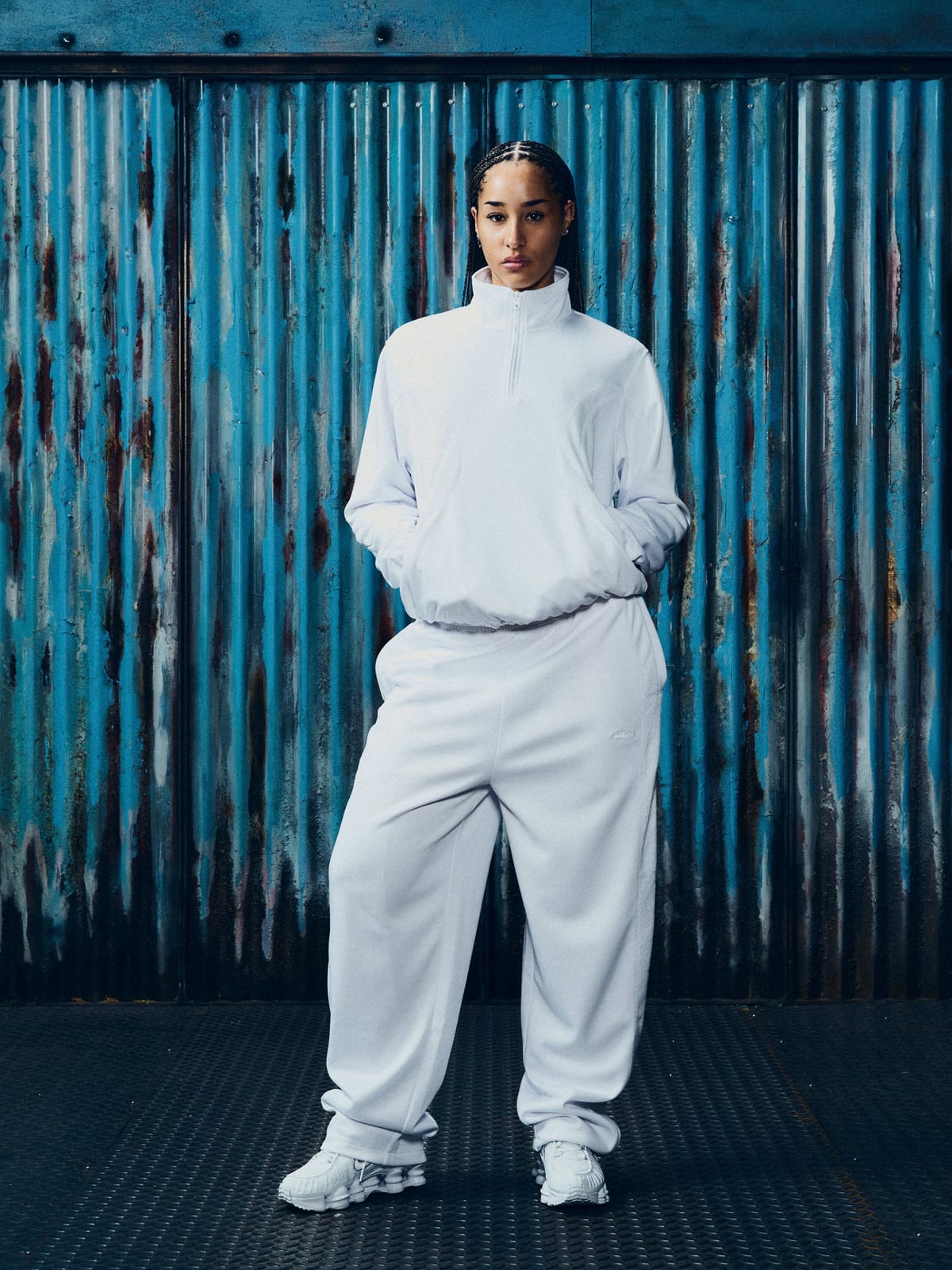 A model in Corteiz's white Shutdown Tricot track top and pant, from the Konnichiwa 10th anniversary collection