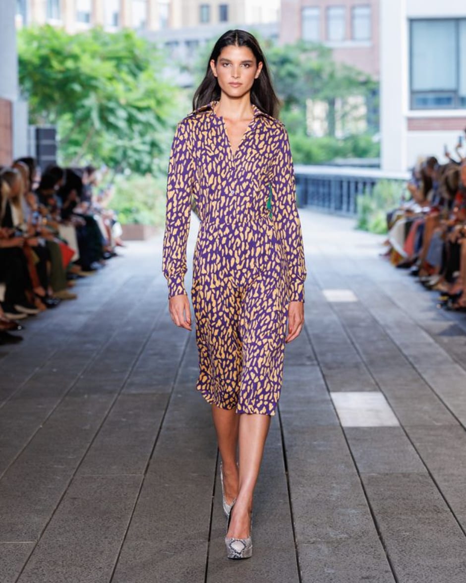 A model in a purple and gold animal-print shirt dress with a collar and long sleeves on the Diane von Furstenberg Spring 2027 runway