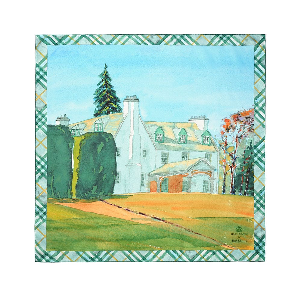 The Highgrove x Burberry Birkhall silk scarf laid flat: a watercolour of a white Scottish house with green dormer windows, tall dark hedges, autumn trees and a lawn, framed by a green and yellow check border
