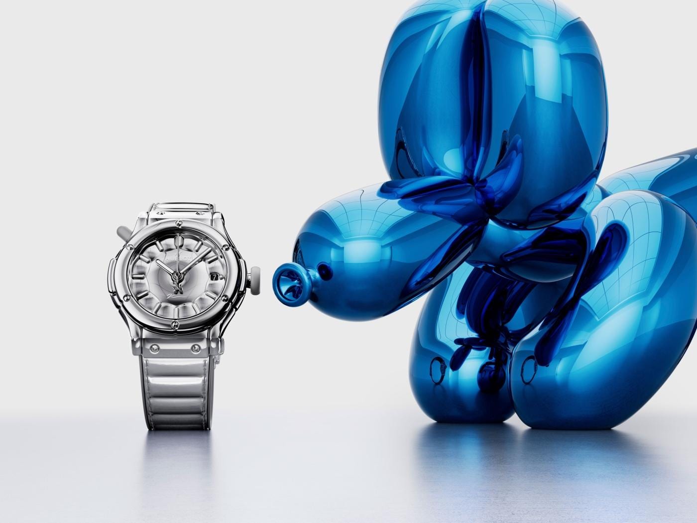 The Hublot x Jeff Koons Classic Fusion Balloon Dog watch in clear sapphire, facing a mirror-polished blue Balloon Dog sculpture