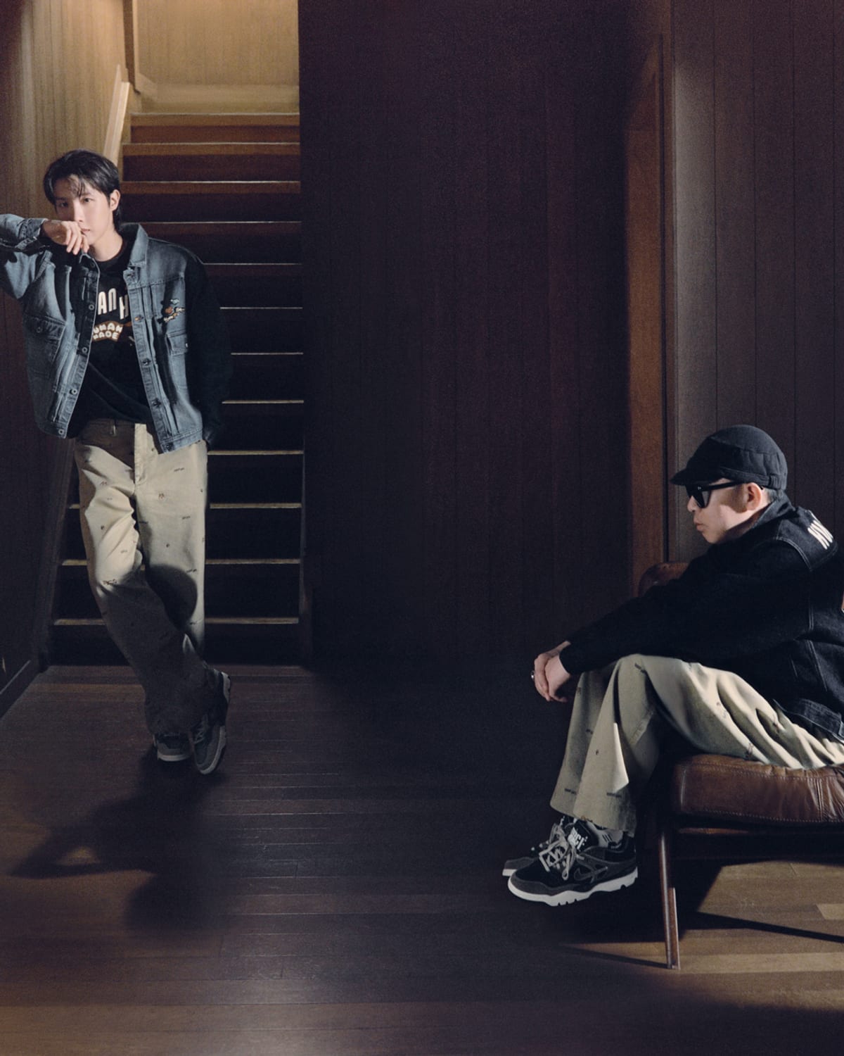 From HUMAN MADE's HUMAN HOPE Season 2 campaign: a denim work jacket over a graphic tee on a wooden staircase, with a second figure seated in the foreground