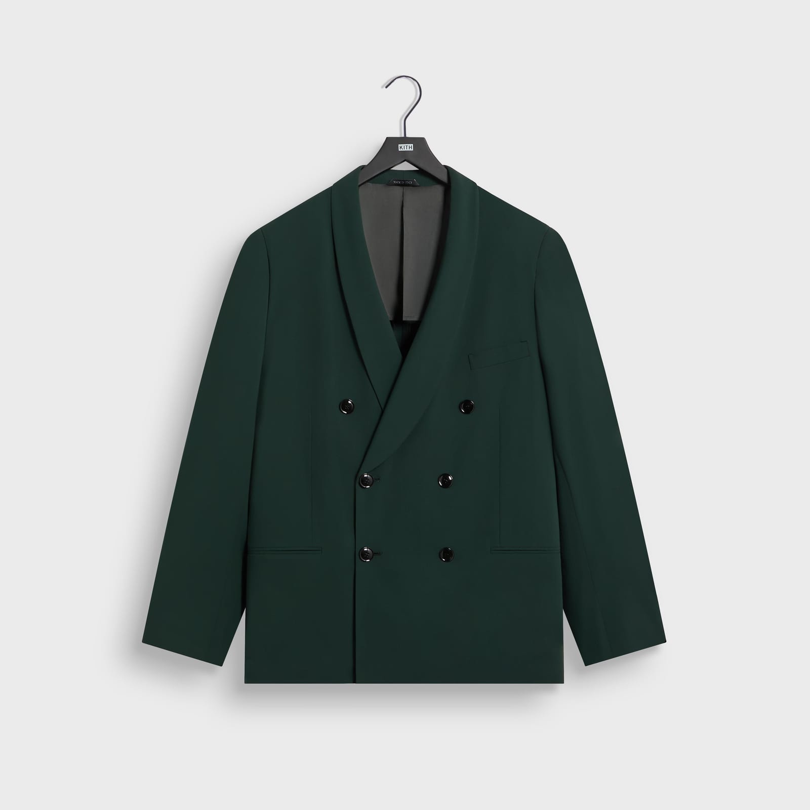 The Giorgio Armani & Kith Ivy double-breasted jacket in Stadium, a deep green virgin wool crepe twill jacket with a shawl collar and six buttons, on a Kith hanger