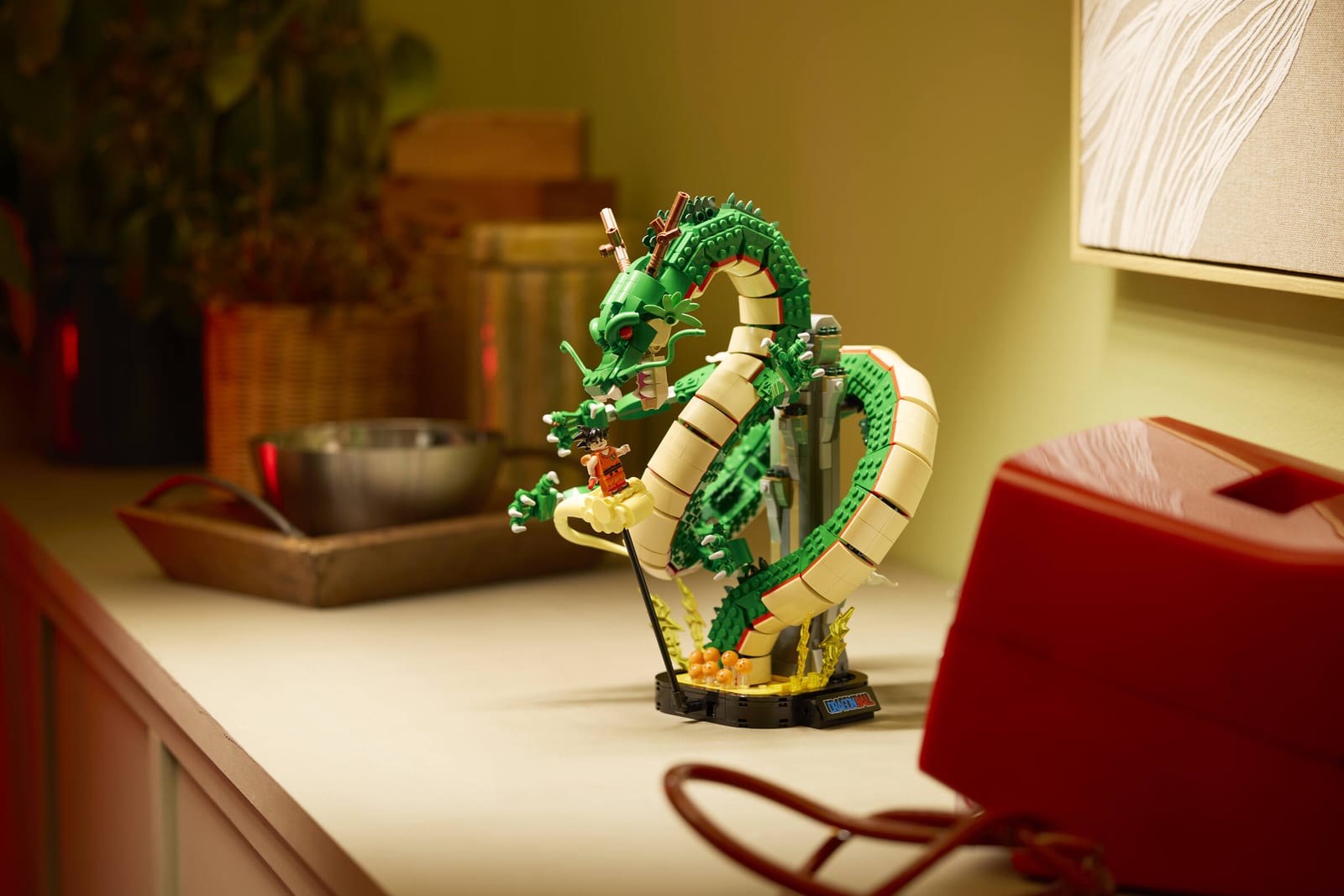 The LEGO Dragon Ball Shenron & Goku model displayed on a kitchen counter next to a red radio