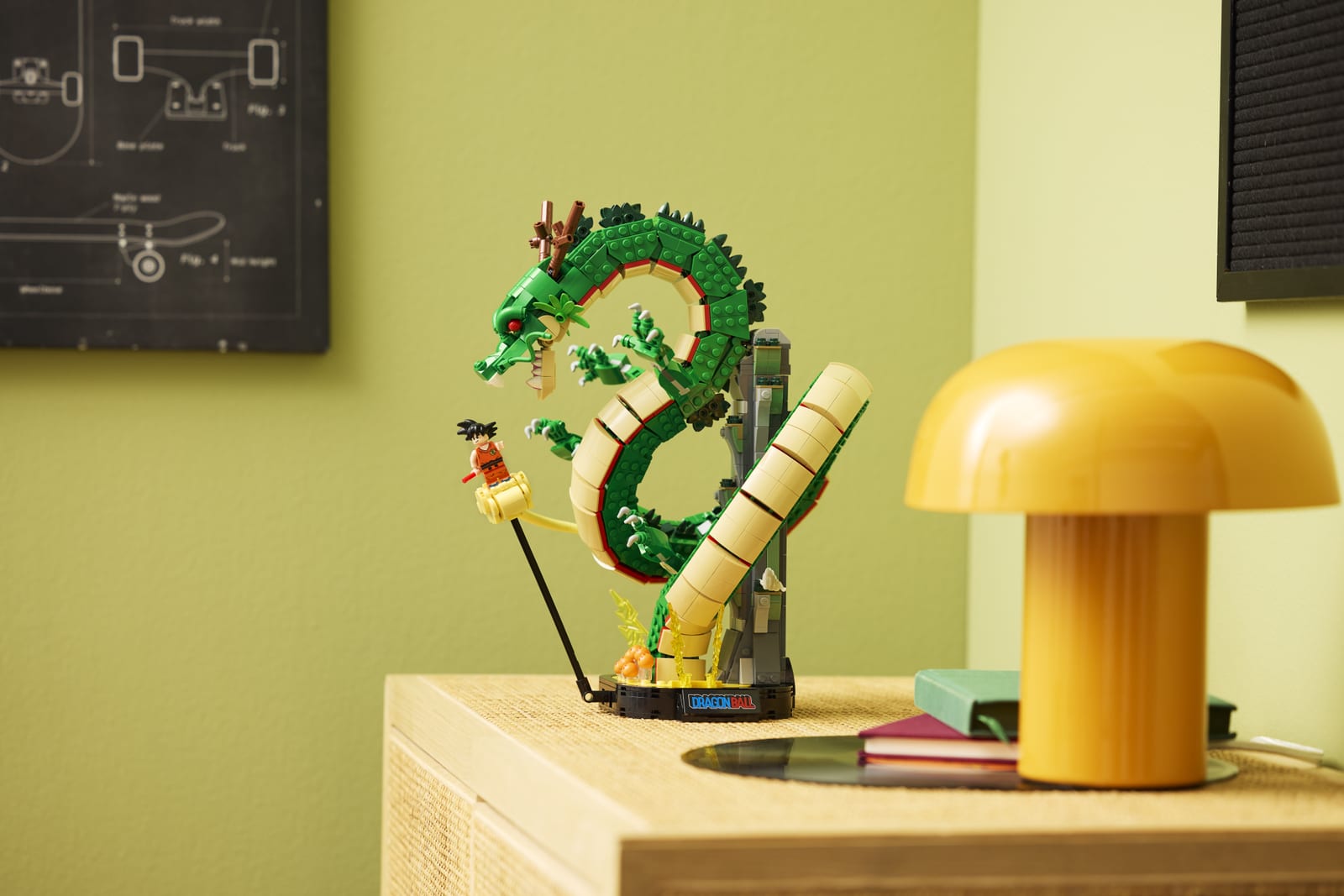 The LEGO Icons Dragon Ball Shenron & Goku set on a sideboard: the green dragon Shenron coiled upward from its base, with Kid Goku on his Kintoun cloud beside it