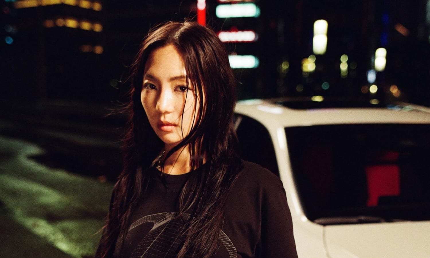 Sara Choi standing beside a Lexus IS at night on a Tokyo street, part of the Future Classic Club campaign