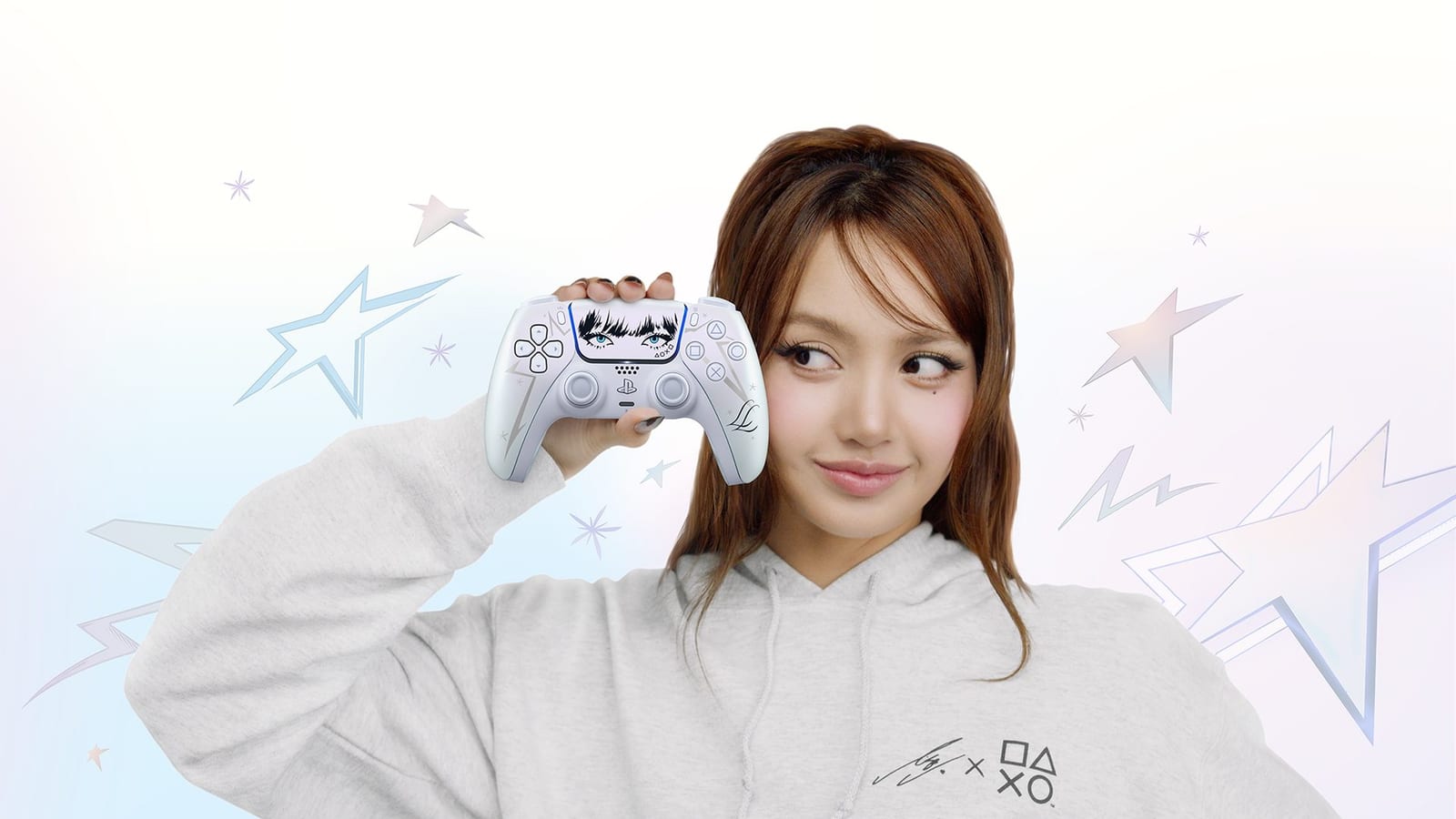 LISA holding the DualSense wireless controller – Lisa Limited Edition, a pearl-white controller with her bangs and eyes on the touch pad, wearing a grey LISA x PlayStation hoodie