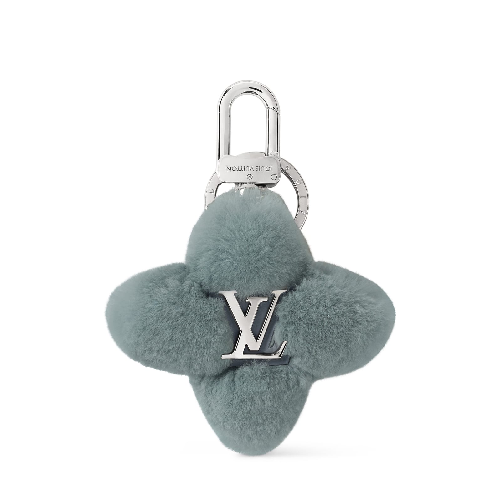A Louis Vuitton bag charm shaped like a four-petal Monogram flower in grey-green fur, with a silver LV initial at its centre and a silver clasp and ring above it
