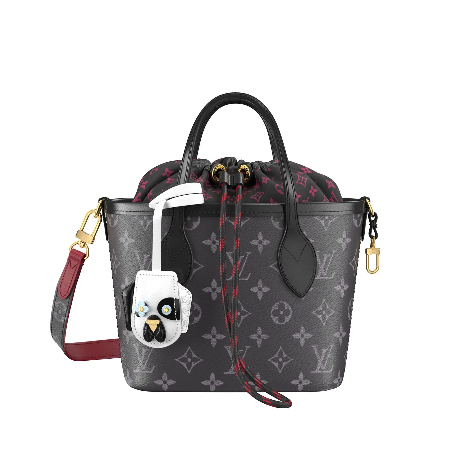 A small Louis Vuitton Neverfull BB tote in black and grey Monogram canvas with a black and magenta Monogram drawstring pouch, a red and black rope drawcord, a red and Monogram shoulder strap, and a white charm with a black-and-white animal face hanging from one handle