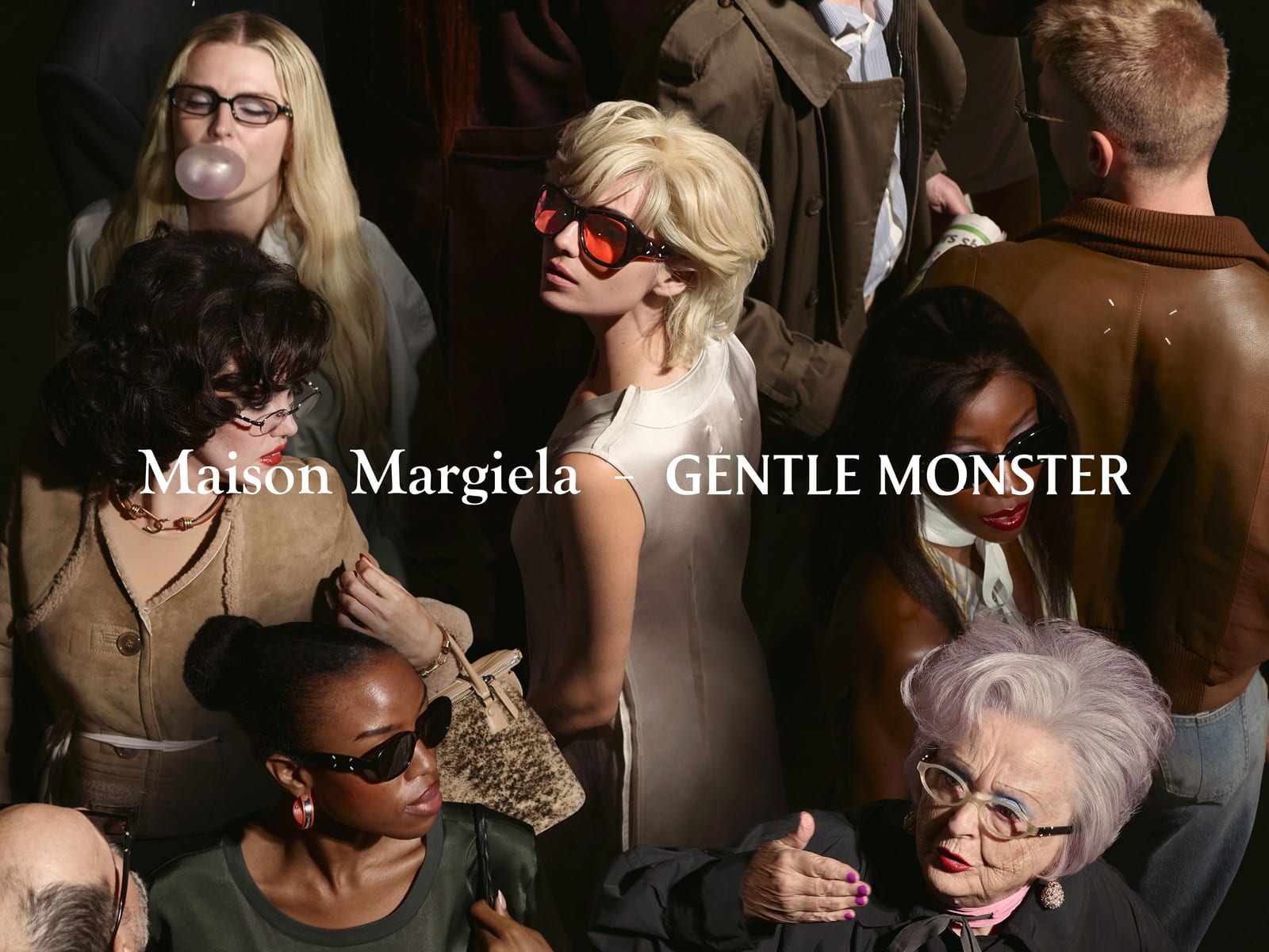 A crowd seen from above in the Maison Margiela and Gentle Monster campaign: a blonde woman in red-lensed black sunglasses and an ivory sleeveless dress at the centre, a woman blowing a bubble in black rectangular glasses, a woman in oval black sunglasses and an older woman in pale oversized frames, with both brands' names across the middle