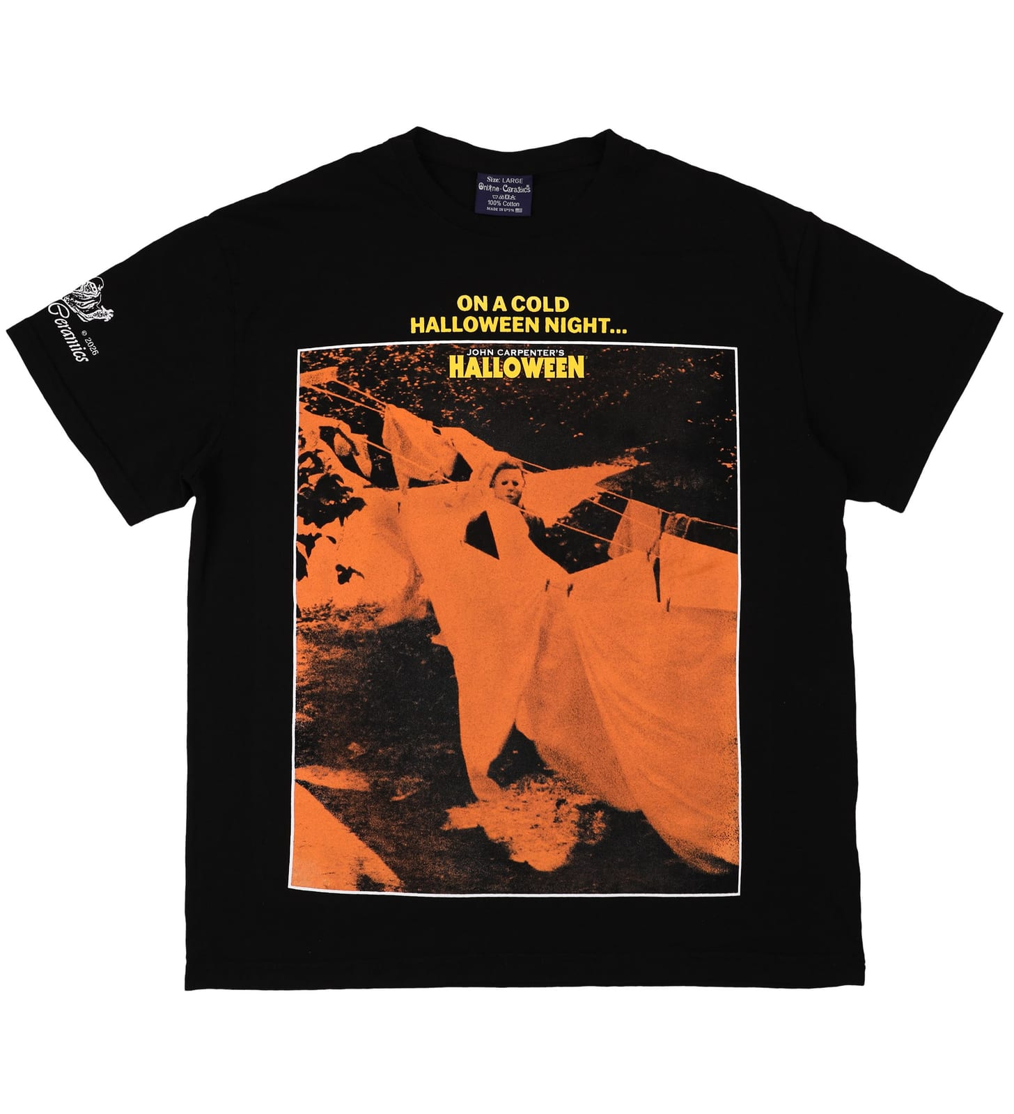 A black tee printed with an orange-tinted film still of Michael Myers among sheets hanging on a washing line, under the words On a cold Halloween night and the John Carpenter's Halloween title