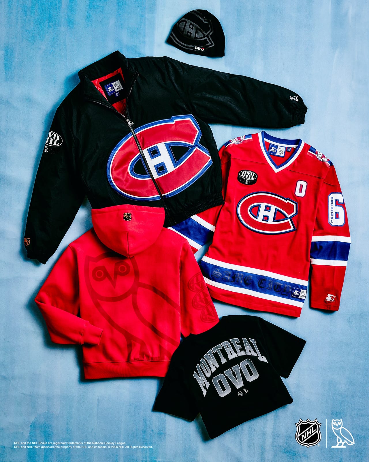 The Montréal Canadiens set laid flat on a pale blue backdrop: a black Starter nylon jacket with a large red, white and blue CH crest, a red long-sleeve hockey top with blue and white stripes and the CH crest, a red hoodie with a large tonal OVO owl on the back, a black tee reading MONTREAL OVO, and a black beanie with the CH knitted in