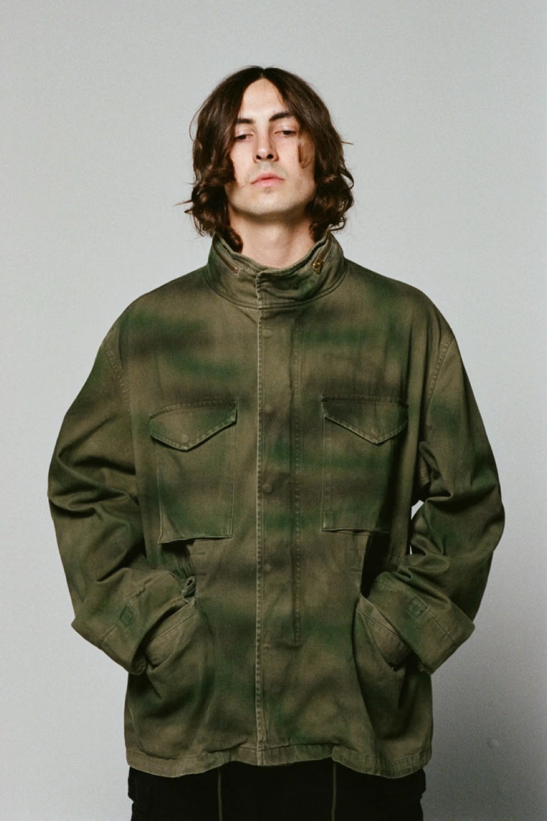 A model in the Supreme x A.PRESSE M-65 jacket with hand-applied green camouflage