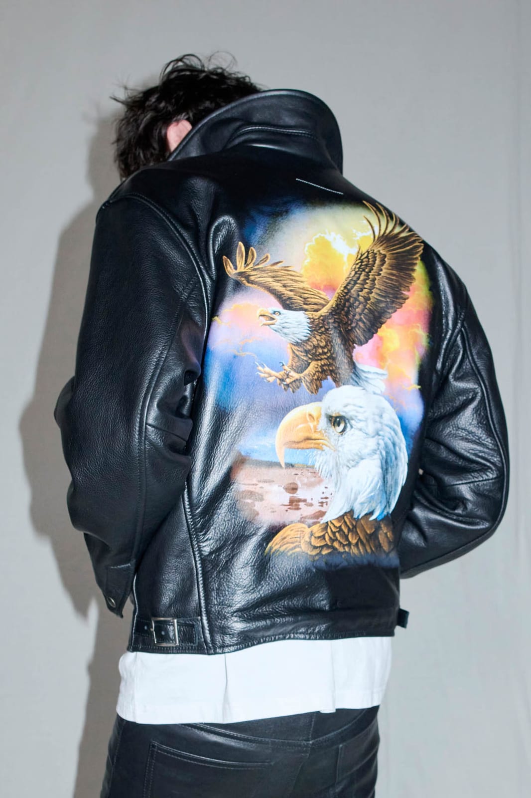 The back of the Supreme x MM6 Maison Margiela eagle leather jacket made with Schott, airbrushed with two bald eagles against a sunset