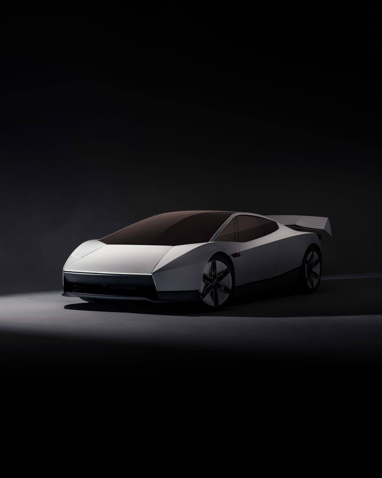 The redesigned Tesla Roadster in white, seen from the front three-quarter in a dark studio: a low wedge nose with a thin light bar, a dark gold-tinted glass canopy, six-spoke wheels and a raised rear wing